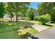 Exterior view of a home with a spacious driveway, three-car garage, and well-maintained grounds at 5971 Dogwood Se Dr, Acworth, GA 30102