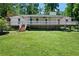 Charming single-story home featuring a full front porch and well-maintained lawn surrounded by mature trees at 5971 Dogwood Se Dr, Acworth, GA 30102