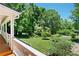 Charming front yard view from porch, showcasing lush green grass and diverse landscaping at 5971 Dogwood Se Dr, Acworth, GA 30102