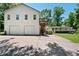 Spacious three-car garage with an upper-level deck overlooking the home and driveway at 5971 Dogwood Se Dr, Acworth, GA 30102