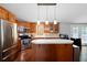 Well-lit kitchen with stainless steel appliances, a center island, and wooden cabinets at 5971 Dogwood Se Dr, Acworth, GA 30102