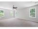 Spacious carpeted main bedroom filled with natural light, thanks to the many windows and the fan at 5971 Dogwood Se Dr, Acworth, GA 30102