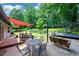 Inviting backyard with seating, a wooden deck, patio area, and lush greenery, perfect for outdoor enjoyment at 609 Hearth Pl, Lawrenceville, GA 30043