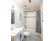 Neat bathroom features shower-tub combo with white subway tiles, updated fixtures, and vanity with chrome hardware at 609 Hearth Pl, Lawrenceville, GA 30043