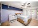 Cozy bedroom featuring a ceiling fan, stylish wall decor, and plenty of natural light, creating a serene space at 609 Hearth Pl, Lawrenceville, GA 30043