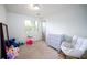 Bright bedroom with plush chair, dresser, and natural light offering a comfortable and versatile space at 609 Hearth Pl, Lawrenceville, GA 30043