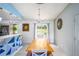 Open dining area featuring a long wooden table, stylish decor, and backyard access through sliding glass doors at 609 Hearth Pl, Lawrenceville, GA 30043