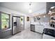Modern kitchen featuring stainless steel appliances, ample counter space, and light-filled window at 609 Hearth Pl, Lawrenceville, GA 30043