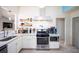Well-equipped kitchen showcasing white cabinets, a gas range, modern appliances, and stylish decor at 609 Hearth Pl, Lawrenceville, GA 30043