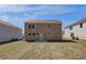 Image of the spacious backyard and back of the house with grass and blue skies at 636 Leafy Branch Way, Mcdonough, GA 30253
