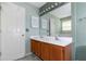 Bathroom with a double sink vanity, a large mirror and a door to the toilet and tub at 9550 Canvasback Ct, Jonesboro, GA 30238