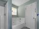 Bathroom featuring a white shower and separate tub with window at 9550 Canvasback Ct, Jonesboro, GA 30238