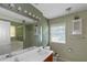 Bathroom featuring a double sink vanity, large mirror, and separate tub and shower at 9550 Canvasback Ct, Jonesboro, GA 30238
