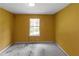 Bedroom featuring yellow walls and a window at 9550 Canvasback Ct, Jonesboro, GA 30238