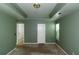 Bedroom showcasing a tray ceiling and natural light from a large window at 9550 Canvasback Ct, Jonesboro, GA 30238