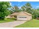 Charming single-story home with a tan siding, a driveway, an attached garage, and a well-manicured lawn at 9550 Canvasback Ct, Jonesboro, GA 30238