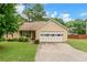 Charming single-story home featuring a well-manicured lawn and attached two-car garage at 9550 Canvasback Ct, Jonesboro, GA 30238