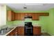 Kitchen featuring wood cabinets and an appliance package with a range and sink at 9550 Canvasback Ct, Jonesboro, GA 30238