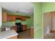 Bright kitchen features wooden cabinets and an open doorway at 9550 Canvasback Ct, Jonesboro, GA 30238