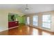 Open-concept living room with hardwood floors and natural light from the windows at 9550 Canvasback Ct, Jonesboro, GA 30238