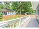 Spacious backyard with a deck, wooden fence, manicured lawn, and mature trees providing shade at 1253 Lucile Sw Ave, Atlanta, GA 30310
