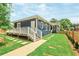 Charming blue home with a welcoming front porch and beautifully landscaped front yard at 1253 Lucile Sw Ave, Atlanta, GA 30310