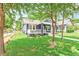 Inviting home with manicured lawn and a charming porch, nestled among mature trees at 1253 Lucile Sw Ave, Atlanta, GA 30310