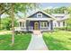 Charming home showcasing a well-manicured lawn, quaint porch, and blue exterior at 1253 Lucile Sw Ave, Atlanta, GA 30310