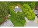 An aerial view of a charming home nestled on a lush, wooded lot in a peaceful neighborhood at 2277 Lazy Days Rd, Dacula, GA 30019