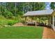 Well-designed backyard patio features a covered area with ample seating and a lush green lawn at 2277 Lazy Days Rd, Dacula, GA 30019