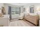 Bedroom features white walls, carpeted floor, window with coverings, and coordinated furniture at 2277 Lazy Days Rd, Dacula, GA 30019