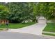 Charming home featuring a well-manicured lawn, mature trees, and a long driveway leading to the garage at 2277 Lazy Days Rd, Dacula, GA 30019