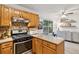 Well-lit kitchen boasts granite counters, stainless steel appliances, and breakfast nook at 2277 Lazy Days Rd, Dacula, GA 30019