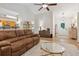 Open-concept living room with hardwood floors, comfortable furniture, and access to the foyer at 2277 Lazy Days Rd, Dacula, GA 30019