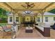 Inviting covered outdoor patio with comfortable seating, dining area, and ceiling fans at 2277 Lazy Days Rd, Dacula, GA 30019