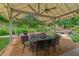 Covered patio has a fan, outdoor seating, and dining table at 2277 Lazy Days Rd, Dacula, GA 30019