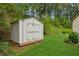 Backyard features a shed, green grass, and surrounding trees at 2277 Lazy Days Rd, Dacula, GA 30019
