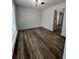 Dining room featuring wood flooring, modern lighting, and neutral paint colors at 2720 Thornbury Way, Atlanta, GA 30349