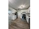 Well-lit kitchen with white cabinets, stainless steel appliances, and hard wood flooring at 2720 Thornbury Way, Atlanta, GA 30349