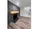 Living room with gray accent wall, fireplace, wooden mantle, and hardwood flooring at 2720 Thornbury Way, Atlanta, GA 30349