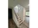 Staircase featuring hardwood floors, white risers, and black metal railings at 2720 Thornbury Way, Atlanta, GA 30349
