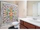 Cozy bathroom showcasing a vanity with storage, a neutral color palette, and a shower with a decorative curtain at 585 Lawton Bridge Sw Rd, Smyrna, GA 30082