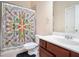 Bathroom features a vanity with a dark wood finish, a large mirror, and a floral shower curtain at 585 Lawton Bridge Sw Rd, Smyrna, GA 30082