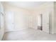 Carpeted bedroom with two windows and a glimpse into the adjacent hardwood floor at 585 Lawton Bridge Sw Rd, Smyrna, GA 30082