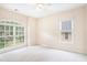 Bright, carpeted bedroom featuring large windows that offer lush views at 585 Lawton Bridge Sw Rd, Smyrna, GA 30082