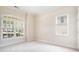 Bright, carpeted bedroom featuring large windows that offer lush views at 585 Lawton Bridge Sw Rd, Smyrna, GA 30082