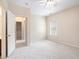 Bright bedroom boasting plush carpet, a ceiling fan, and a doorway to an adjoining bathroom at 585 Lawton Bridge Sw Rd, Smyrna, GA 30082