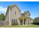Rear exterior view of home with large lawn and covered patio at 585 Lawton Bridge Sw Rd, Smyrna, GA 30082