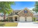 Charming two-story brick home with lush landscaping and a two-car garage at 585 Lawton Bridge Sw Rd, Smyrna, GA 30082