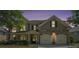 Evening shot of a brick home featuring a two-car garage and manicured landscaping at 585 Lawton Bridge Sw Rd, Smyrna, GA 30082